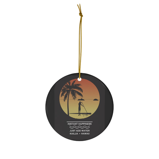 Black ceramic ornament with sunset stand-up paddler scene, palm tree, Mokulua islands and Instant Happiness Just Add Water Kailua Hawaiʻi design.