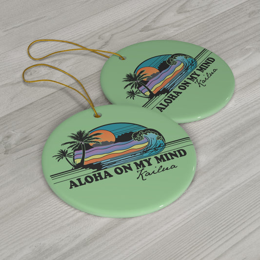 Green ceramic ornament with Aloha on My Mind Kailua design featuring a retro sunset, palm trees and ocean wave.