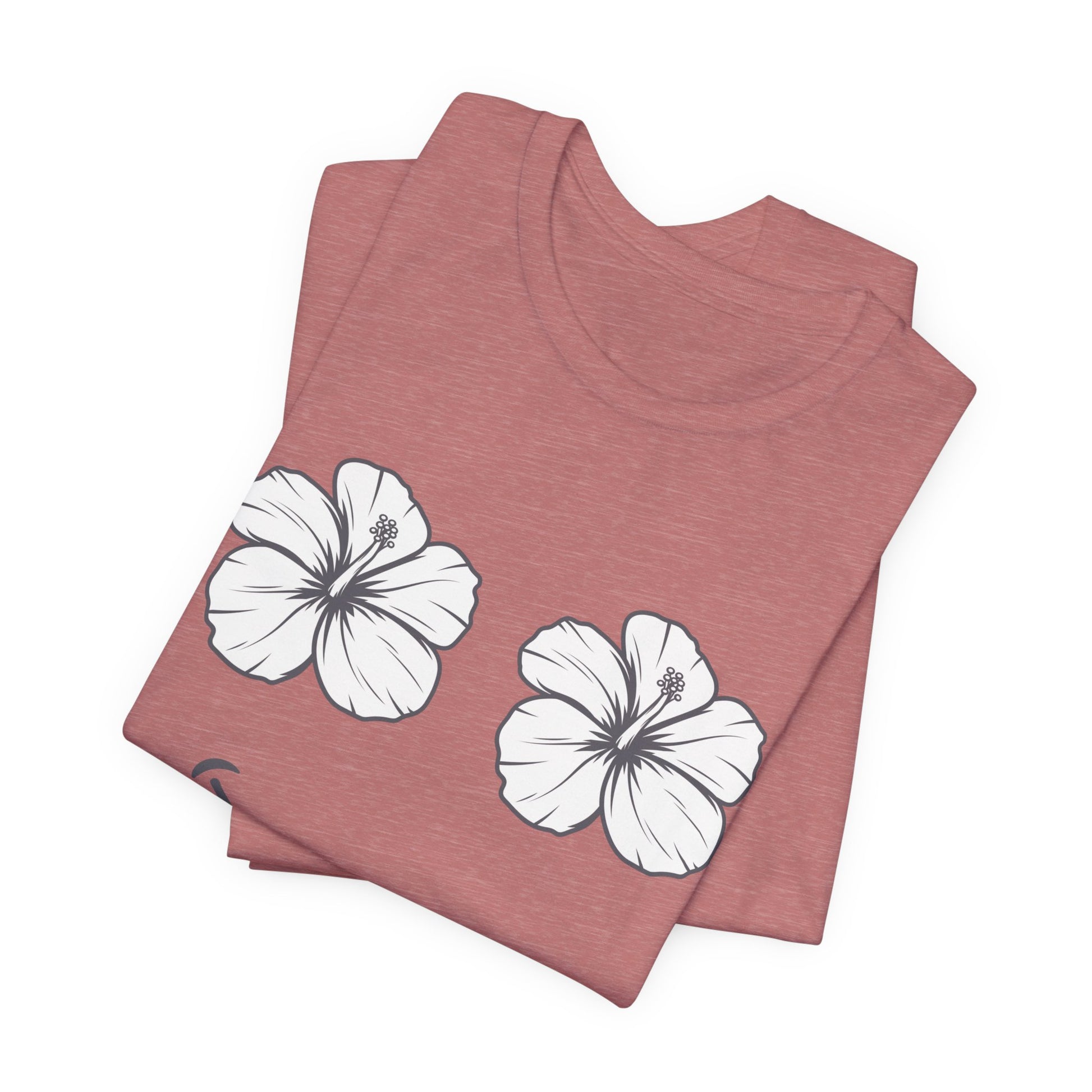 A folded heathered dusty rose t-shirt featuring two white hibiscus flowers printed on the front, displayed on a clean white background.