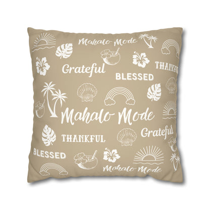 A square throw pillow in a warm beige color, printed with white tropical-themed illustrations and words including 'Mahalo Mode', 'Grateful', 'Blessed', and 'Thankful'.