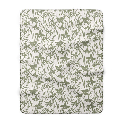 Sage green orchid-and-leaf print sherpa fleece blanket with a warm white background and rounded corners.