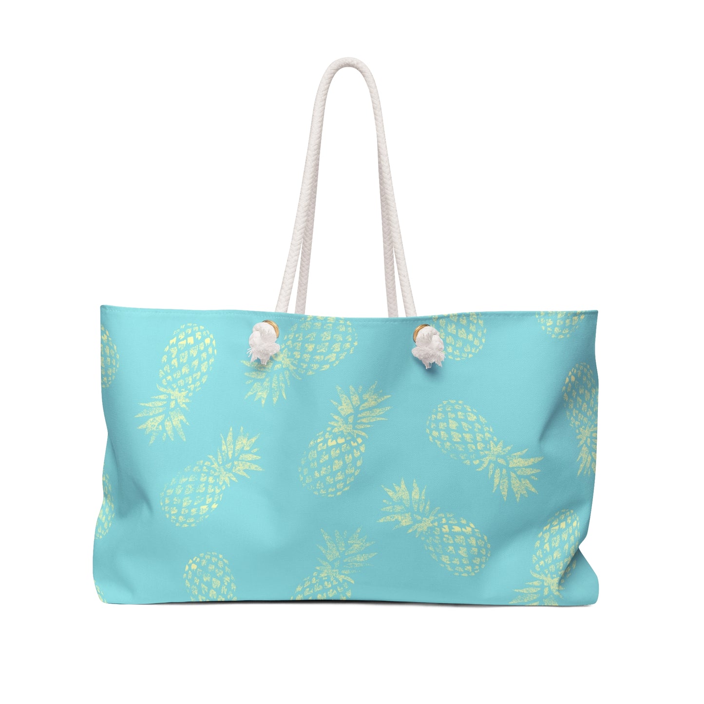 A light blue tote bag with a repeating yellow pineapple pattern and white rope handles, shown against a plain white background.