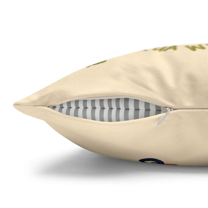 A close-up of a cream-colored throw pillow with a zipper opening, showing a gray and white striped inner cushion and a small green graphic print on the front.