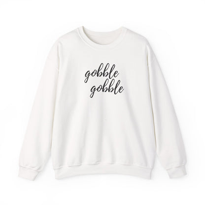 An off-white crewneck sweatshirt with the words 'gobble gobble' printed in black cursive script across the chest, displayed on a clean white background.