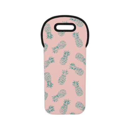 A pink neoprene wine tote featuring a repeating pattern of teal pineapples, with a black trim and a cutout handle at the top, shown on a plain white background.