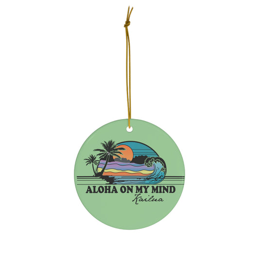 Green ceramic ornament with Aloha on My Mind Kailua design featuring a retro sunset, palm trees and ocean wave.