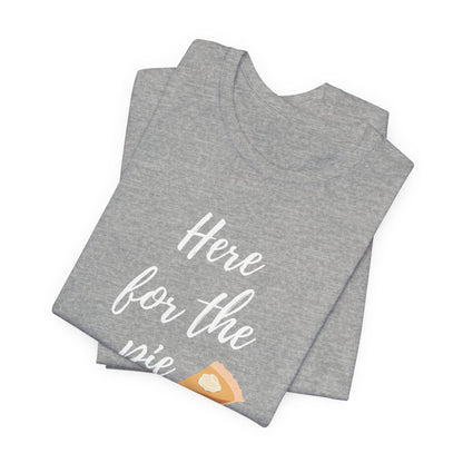 A folded heather gray t-shirt with white script text reading 'Here for the pie' and a small pie slice graphic near the bottom, shown on a plain white background.