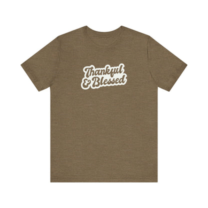 A heather olive short-sleeve t-shirt with a white graphic text print reading 'Thankful & Blessed' on the chest, displayed against a solid white background.