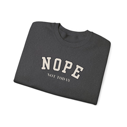 A folded dark grey crewneck sweatshirt with the words 'NOPE NOT TODAY' printed on the front.