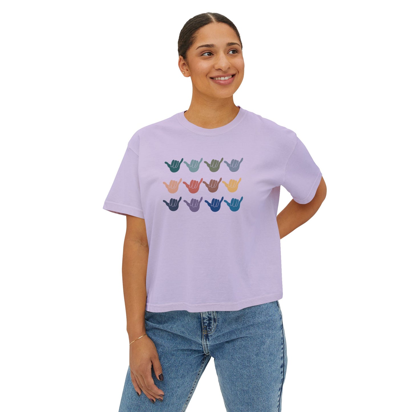 Woman wearing a lavender t-shirt with '12 shakas' graphic on a white background