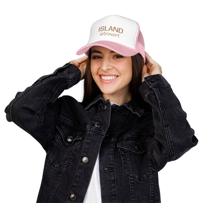 Person wearing a black denim jacket and pink cap with text 'island introvert' on a white background