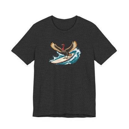 Dark gray surfing turkey Thanksgiving T-shirt featuring a teal wave and vintage-inspired island artwork.