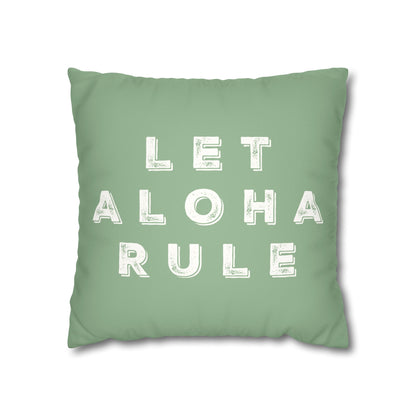 A square mint green throw pillow featuring the phrase 'LET ALOHA RULE' printed in distressed white block letters, shown against a plain white background.