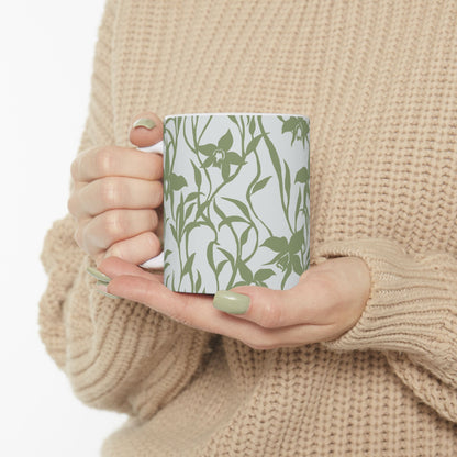 Woman in sweater holding an Orchid Sage coffee mug with tropical orchid print by Global Village Kailua