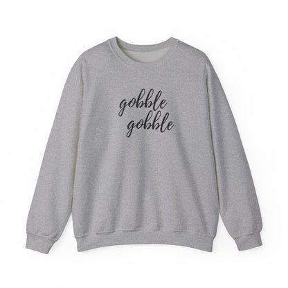 A sport grey crewneck sweatshirt with the words 'gobble gobble' printed in black cursive text across the chest, displayed on a clean white 