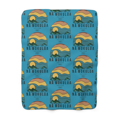 Nā Mokulua Kailua Hawaiʻi sherpa fleece blanket with colorful island print and plush cream backing