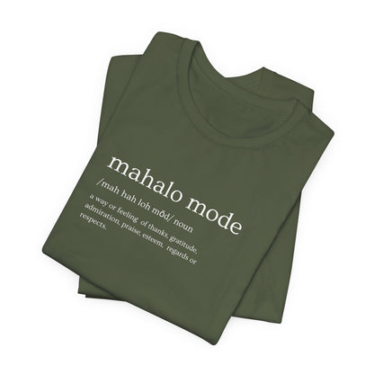 A folded olive t-shirt with a white printed dictionary-style definition of 'mahalo mode' on the chest, shown against a plain white background.