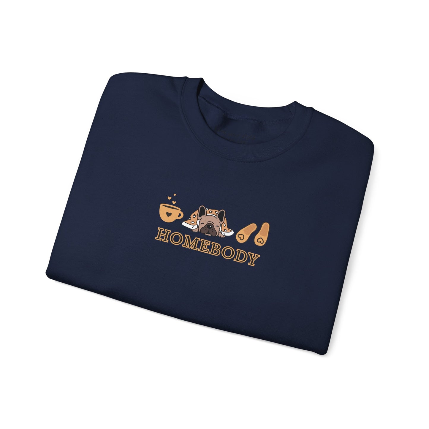 A folded navy crewneck sweatshirt featuring a central graphic of a dog under a blanket, house slippers, coffee cups and the word 'HOMEBODY' printed below it.