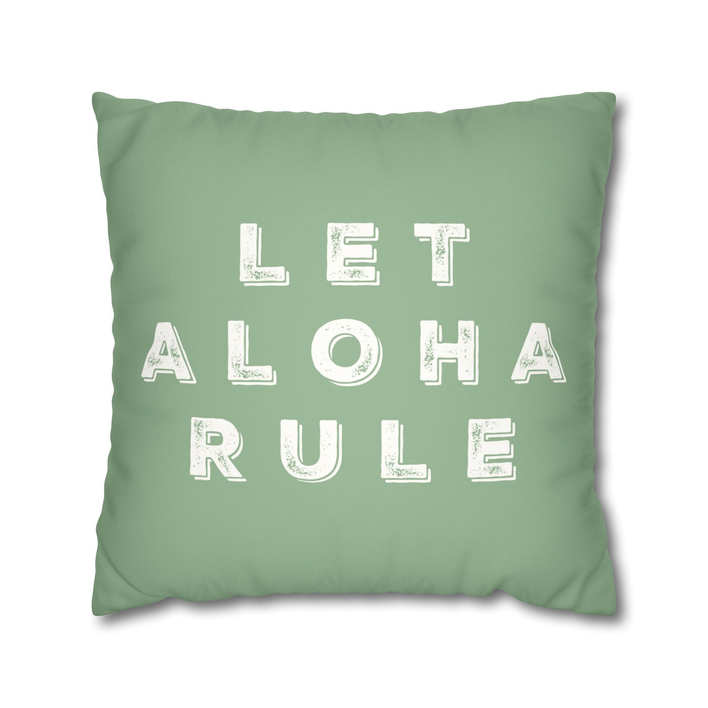 A square mint green throw pillow featuring the phrase 'LET ALOHA RULE' printed in distressed white block letters, shown against a plain white background.