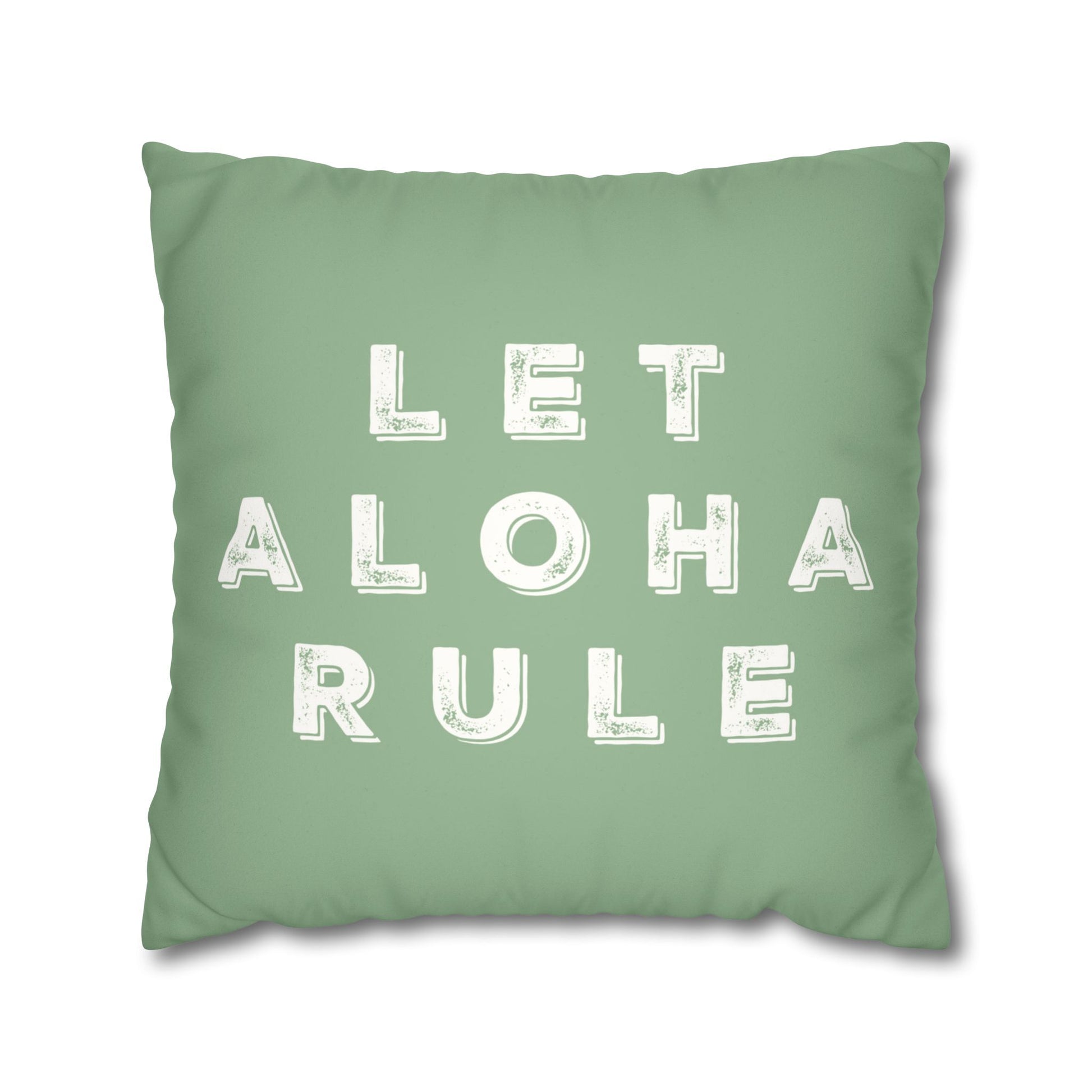 A square mint green throw pillow featuring the phrase 'LET ALOHA RULE' printed in distressed white block letters, shown against a plain white background.