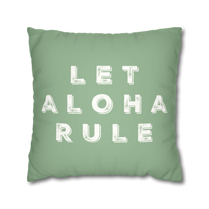 A square mint green throw pillow featuring the phrase 'LET ALOHA RULE' printed in distressed white block letters, shown against a plain white background.