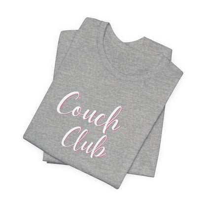 A folded heather gray t-shirt with 'Couch Club' printed in white script with a pink outline on the front, set against a plain white background.