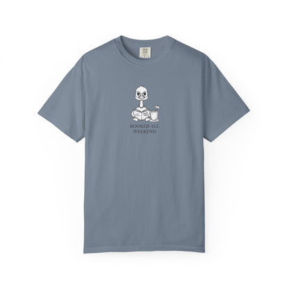 A dusty blue comfort colors t-shirt with design of a nene goose reading a book and text 'booked all weekend' 