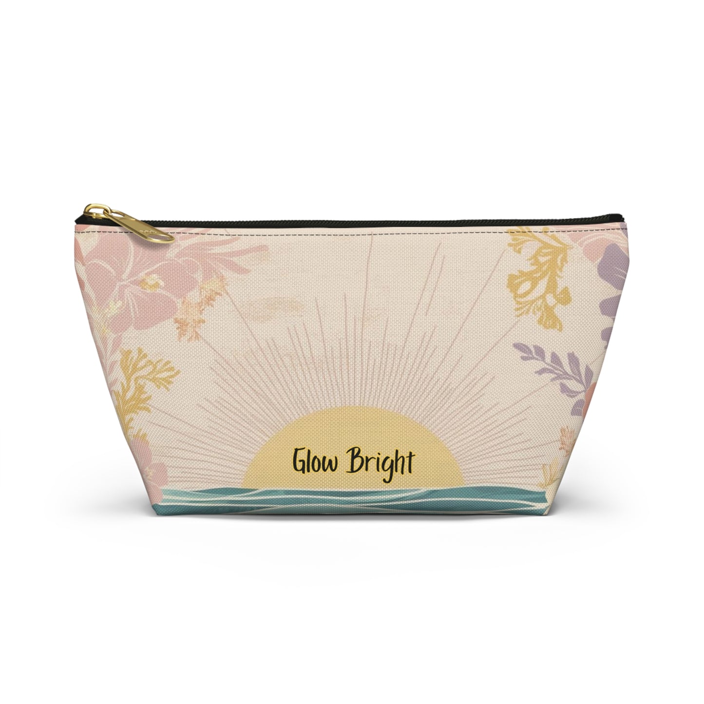 A small zippered pouch with a cream background and a printed sunset design featuring pink and purple floral elements, a yellow sun, and the words 'Glow Bright' on the front.