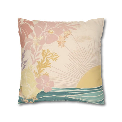 A square decorative throw pillow featuring a retro-style tropical sunset print with pink hibiscus flowers, a yellow sun, and teal ocean waves on a cream background.