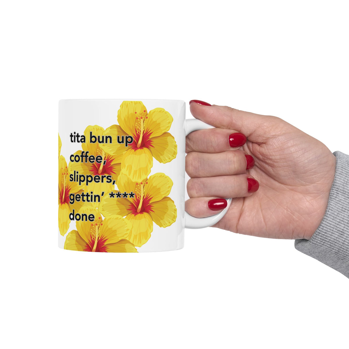 woman hand holding Tita Bun coffee mug with yellow hibiscus design by Global Village Kailua