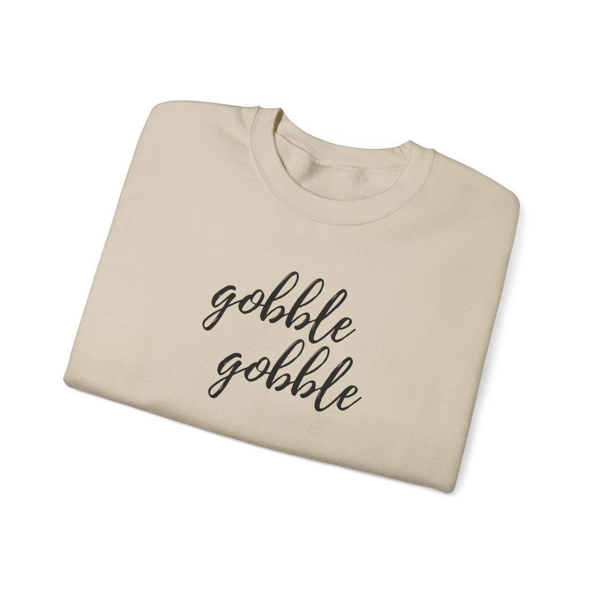 A folded beige crewneck sweatshirt with the phrase 'gobble gobble' printed in black cursive script across the chest, shown on a clean white background.
