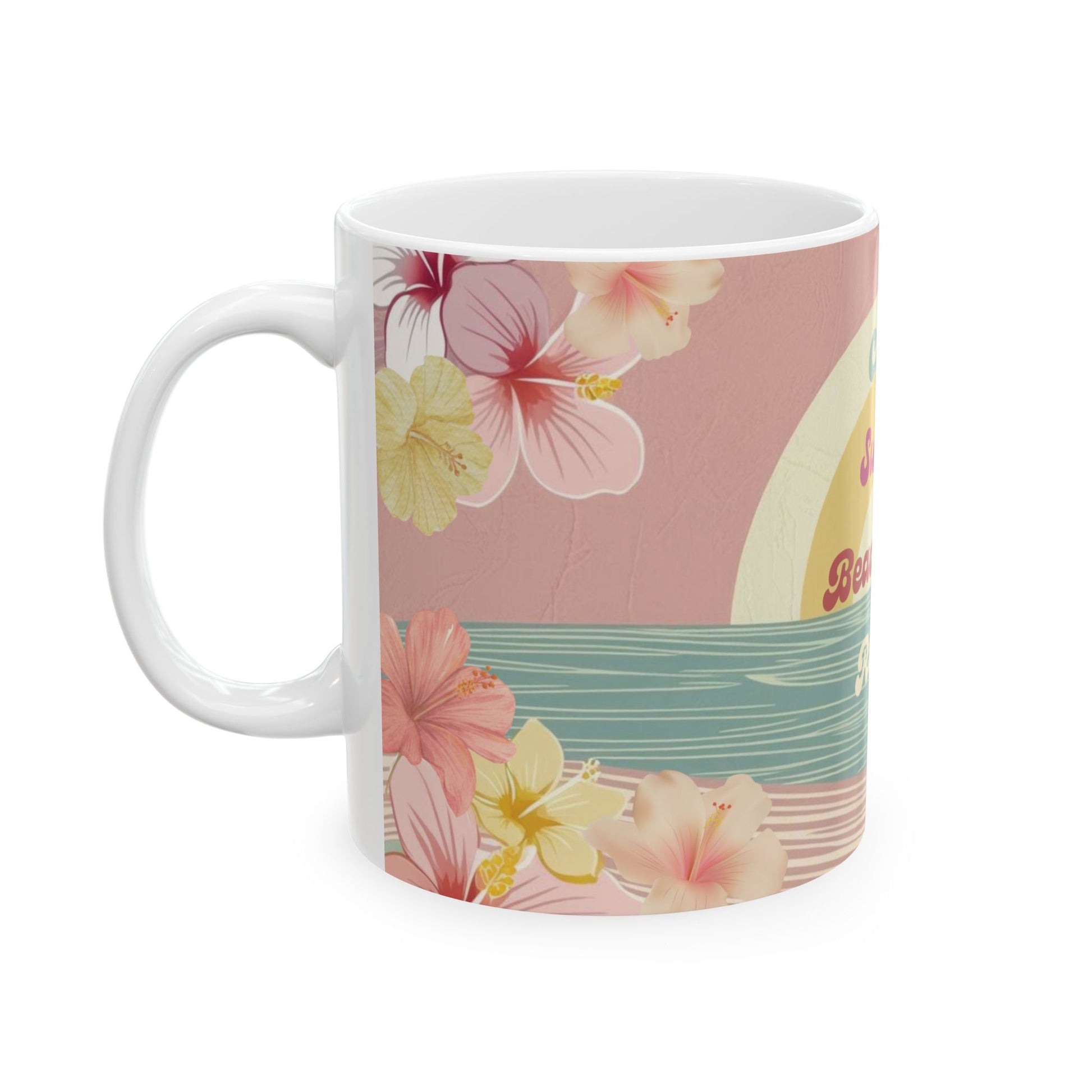 A white ceramic mug featuring a tropical floral design with pink and yellow hibiscus flowers, a teal wave pattern, and a partial cream-colored sun on a dusty pink background.