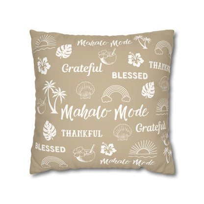 A square throw pillow in a warm beige color, decorated with white tropical-themed illustrations and words including 'Mahalo Mode', 'Grateful', 'Blessed', and 'Thankful'.