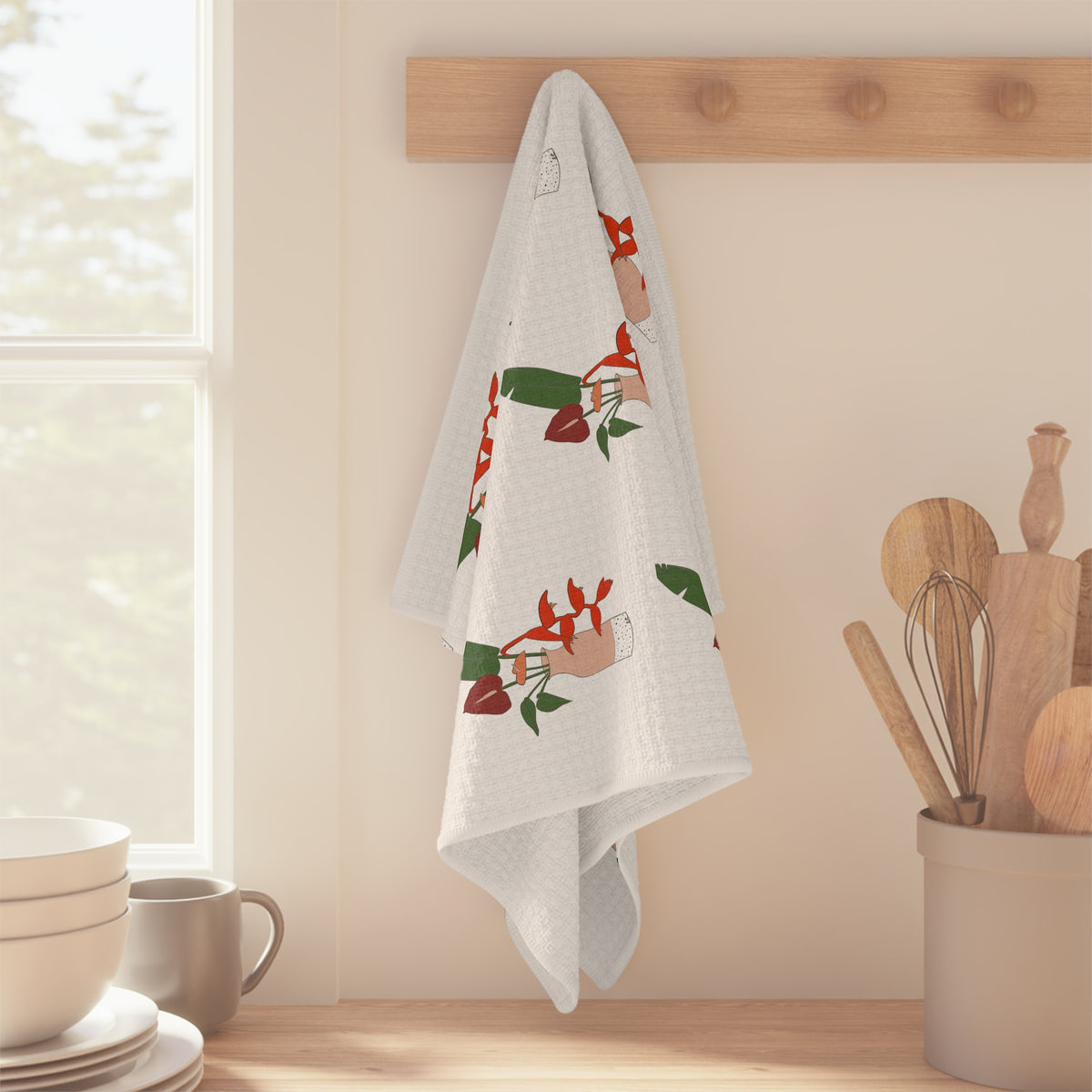 Anthurium Bouquet Hawaiʻi kitchen towel with red anthuriums and tropical green leaves on a neutral background hanging on wood peg in bright kitchen