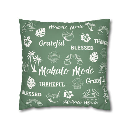 A square throw pillow in sage green with a white tropical-themed print featuring the words 'Mahalo Mode', 'Grateful', 'Blessed', and 'Thankful' along with palm trees, hibiscus flowers, shells, and rainbows, shown on a plain white background.