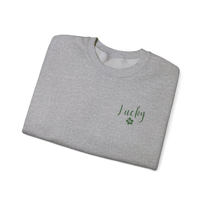 Folded gray t-shirt with Lucky Hibiscus text on a grey background