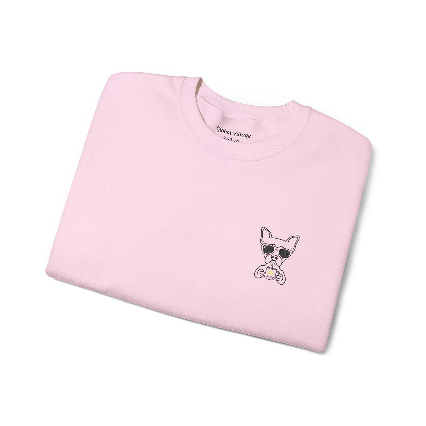 Folded light pink sweatshirt with an embroidered dog drinking a cup of coffee on a white background