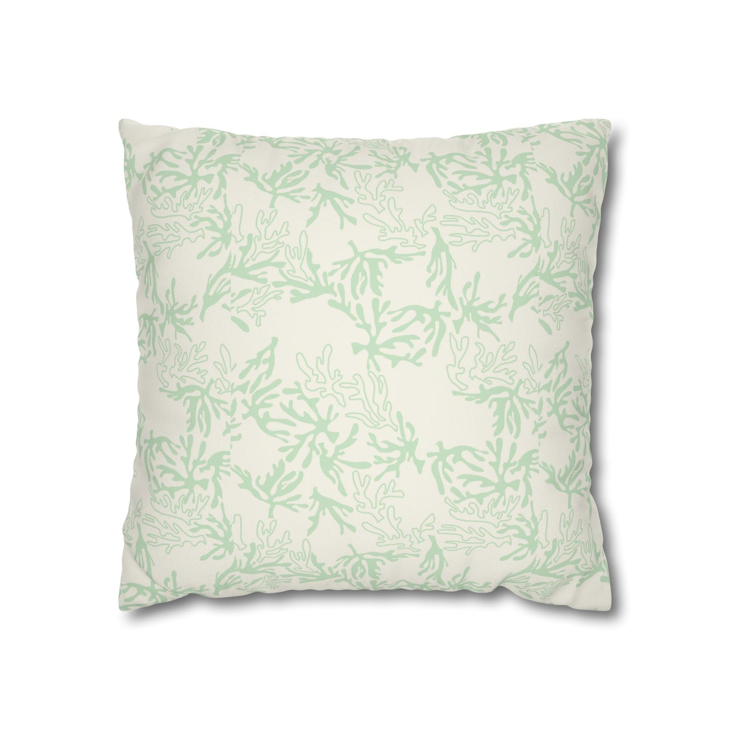 A square decorative throw pillow featuring a light sage green coral pattern on an off-white background, shown against a plain white studio backdrop.