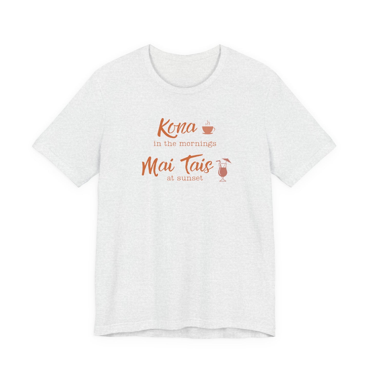 An ash short-sleeve crewneck t-shirt with a coral orange graphic on the chest that reads 'Kona in the mornings Mai Tais at sunset' with small coffee and cocktail illustrations.