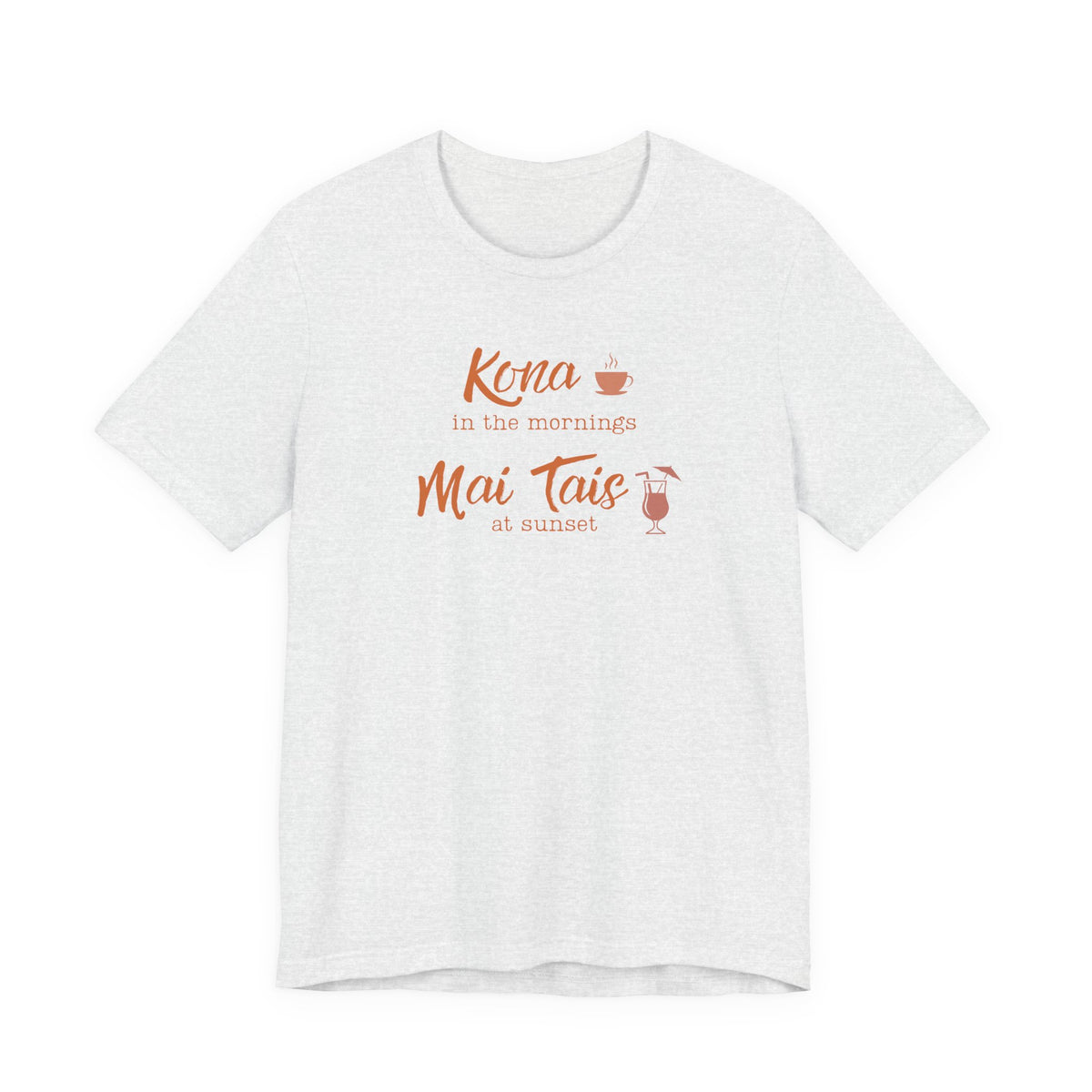 An ash short-sleeve crewneck t-shirt with a coral orange graphic on the chest that reads 'Kona in the mornings Mai Tais at sunset' with small coffee and cocktail illustrations.