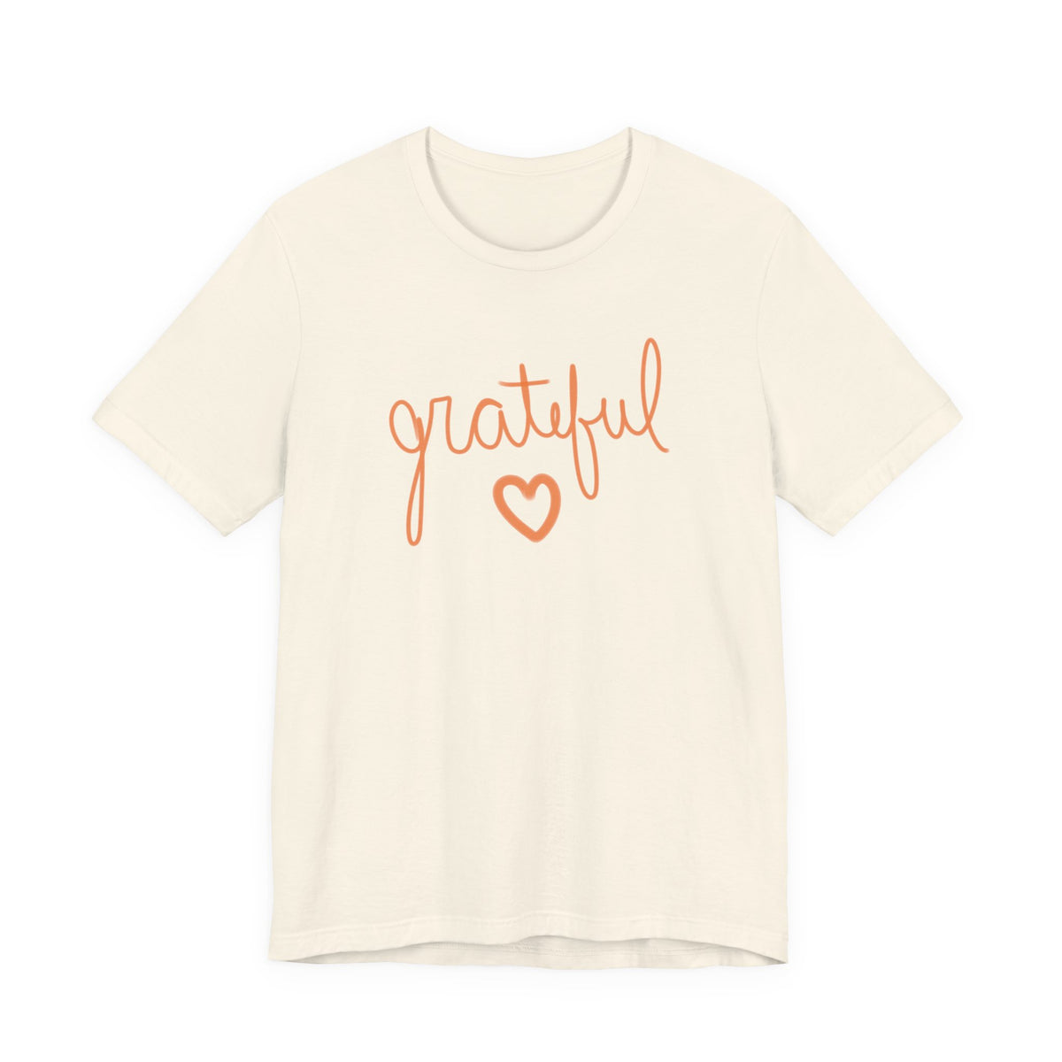 An off-white short-sleeve crewneck t-shirt featuring the word 'grateful' in orange cursive script and a matching orange heart outline on the chest, displayed against a solid white background.