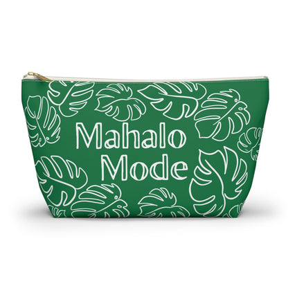 A green zippered pouch with a white monstera leaf pattern and the words 'Mahalo Mode' printed in white, shown on a clean white background.