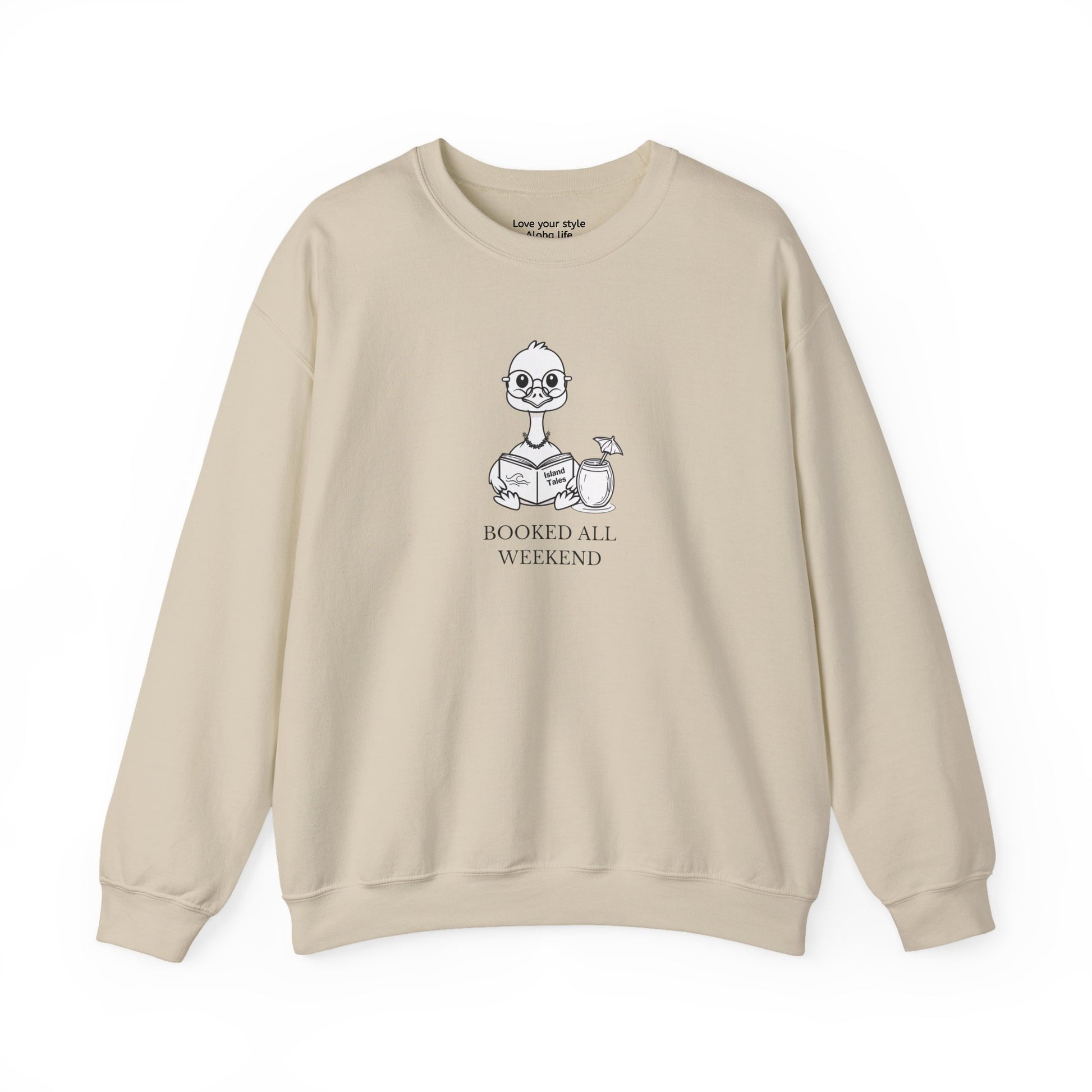 Sand sweatshirt with graphic print of a cartoon nene goose sitting reading a book with a cocktail next to it with text 'BOOKED ALL WEEKEND'