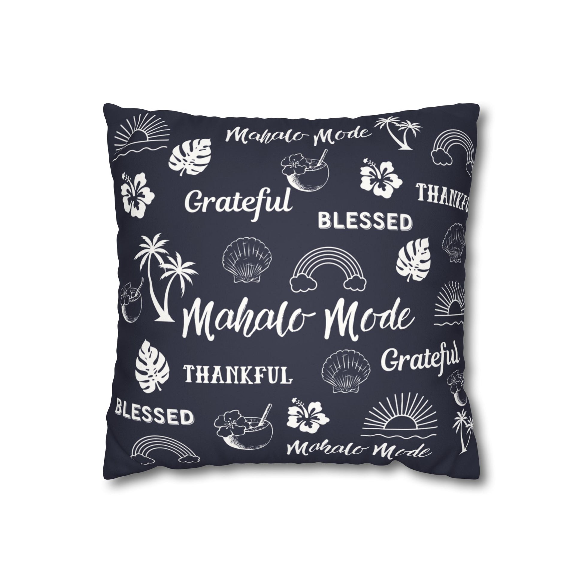 A square throw pillow in dark navy blue with a white tropical-themed print featuring palm trees, monstera leaves, seashells, rainbows, hibiscus flowers, and words like 'Mahalo Mode', 'Grateful', and 'Thankful'.