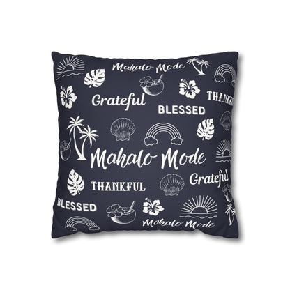 A square throw pillow in dark navy blue with a white tropical-themed print featuring palm trees, monstera leaves, seashells, rainbows, hibiscus flowers, and words like 'Mahalo Mode', 'Grateful', and 'Thankful'.