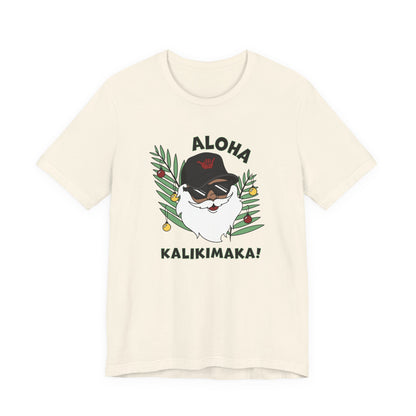 Natural Santa Kalikimaka unisex T-shirt with hand-drawn Santa wearing sunglasses and throwing a shaka surrounded by tropical palm leaves.