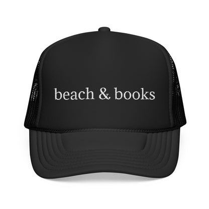 Black trucker hat with white embroidery 'beach & books'