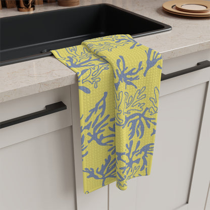 Coral Yellow and Grey microfiber kitchen towel featuring an original island-inspired coral reef pattern by Global Village Kailua draped over the edge of a black sink in a modern kitchen setting.