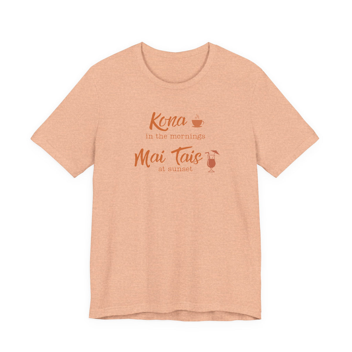A heather peach short-sleeve t-shirt with a coral orange graphic on the chest that reads 'Kona in the mornings Mai Tais at sunset' with small coffee and cocktail illustrations, displayed on a clean white background.