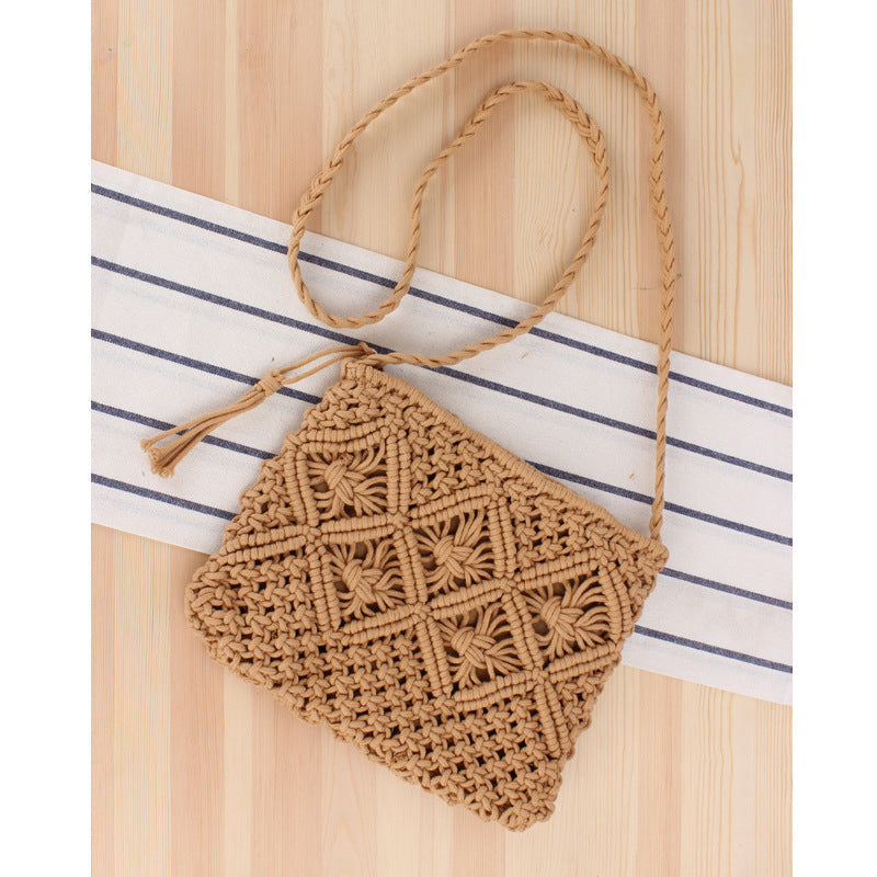 Brown woven handbag with a strap on a striped fabric background